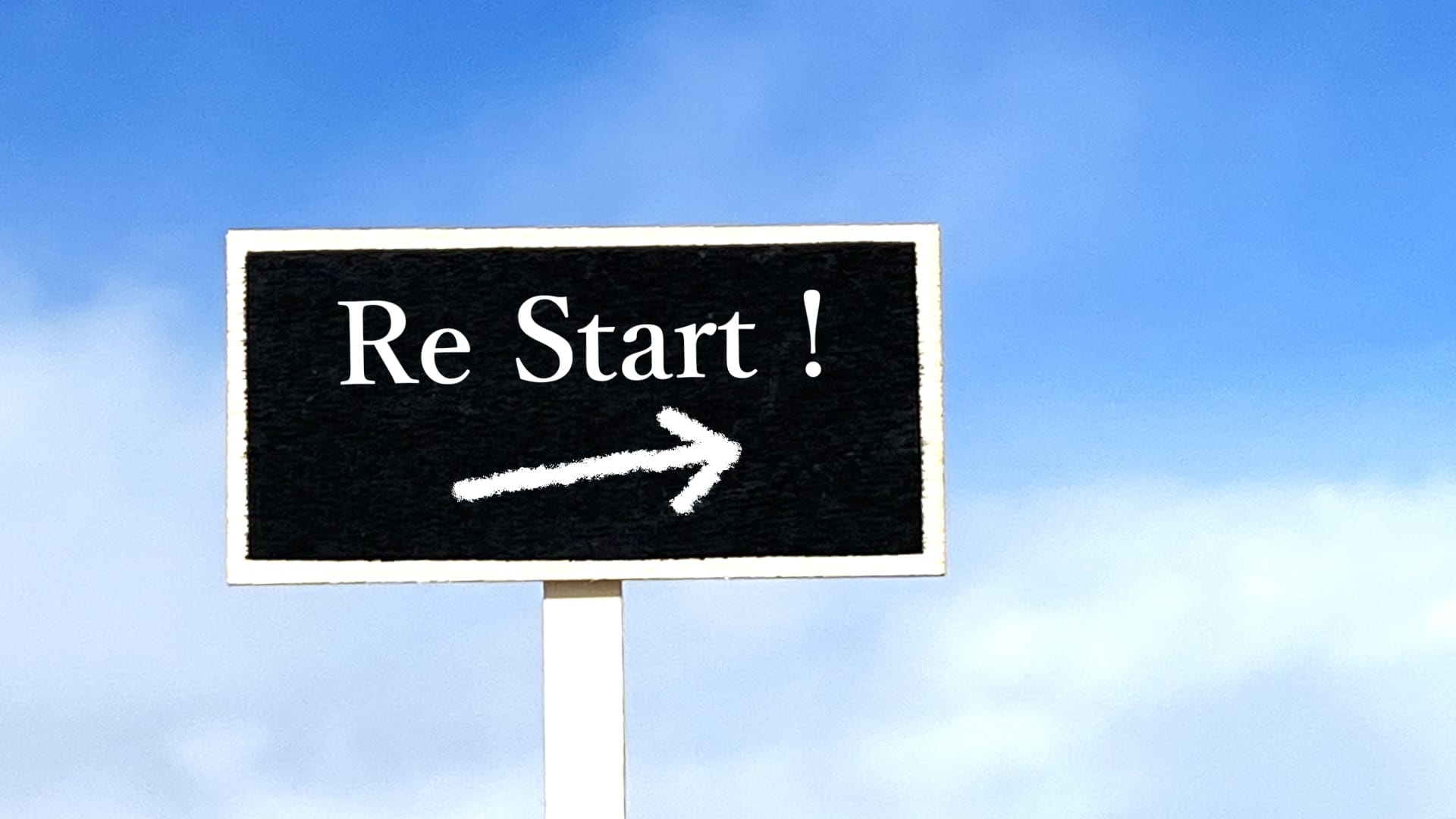 Signboard reading 'Re Start!' with a white right-pointing arrow against a blue sky.